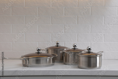 Set of new clean cookware on countertop in kitchen