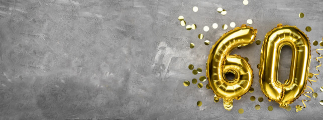Yellow foil balloon number, number sixty on a concrete background. Greeting card with the inscription 60. Anniversary concept. for anniversary, birthday, new year celebration. banner,
