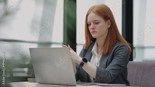 professional lawyer or economist is reading agreement on laptop display, working in office