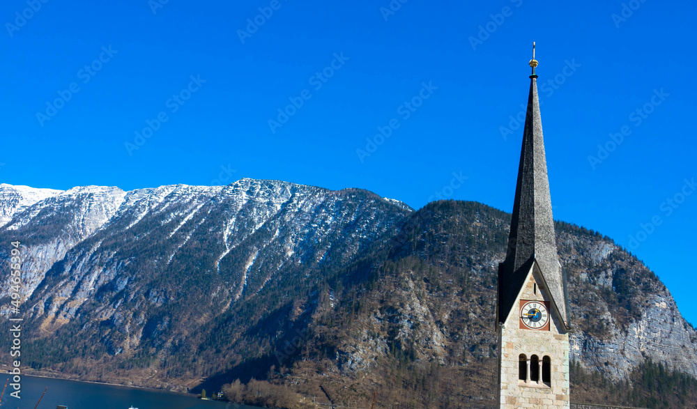 Panoramic view of the famous  parish church of Maria Himmelfahrt in Hallstatt. The Dachstein mountains in the background. Austrian Alps Salzkammergut, Hallstatt, Austria