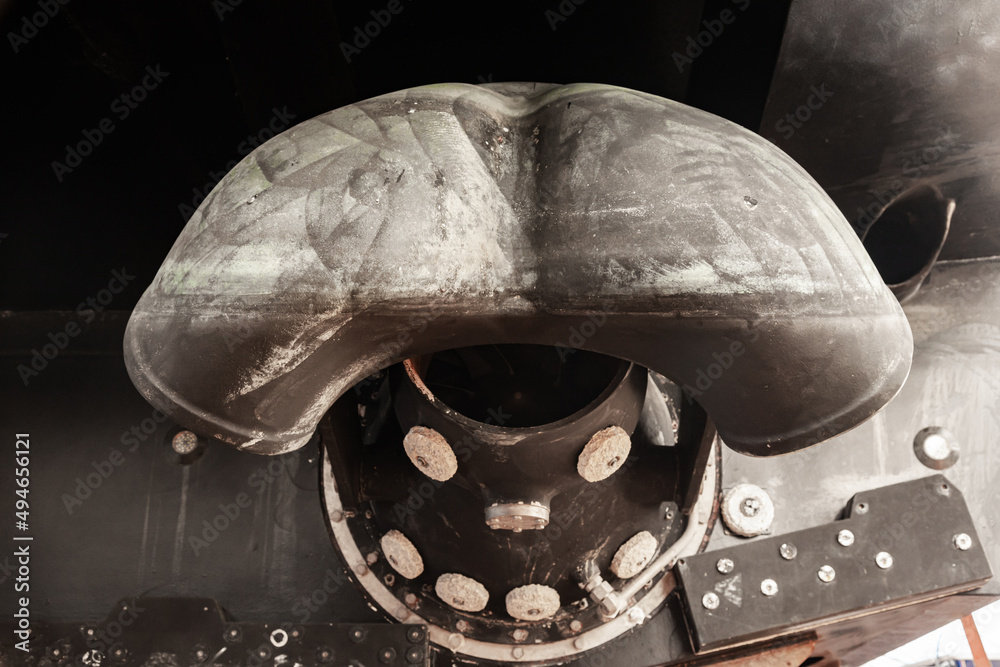 The back of a yacht with a water jet engine in the form of a turbine
