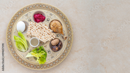 The Seder Plate for Jewish holiday Pesach on marble background with copy space. Special plate containing symbolic foods eaten at the Pesach Seder.