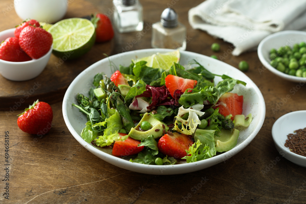 Healthy leaf salad with strawberry and avocado