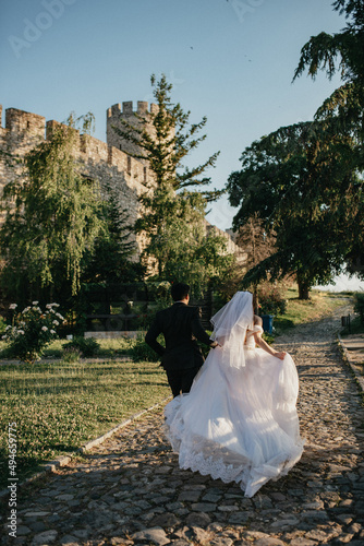 Happy couple in love. Gorgeous bride and stylish groom. Romantic moments of newlyweds. Wedding photo.
