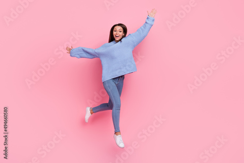 Full length photo of young cheerful girl have fun go walk run jump energetic isolated over pink color background