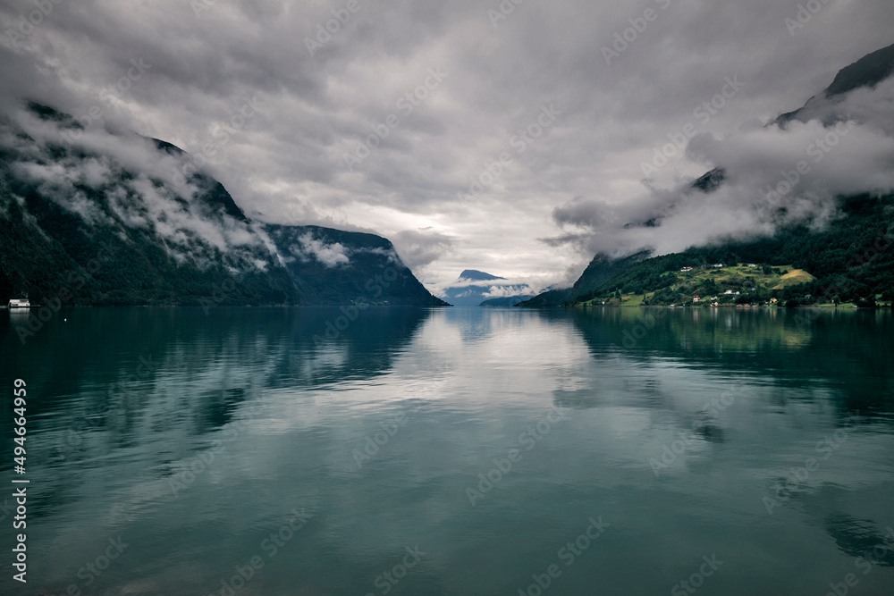 fjord of norway and mountains on a summer rainy day
