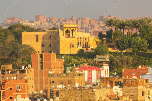 Cairo, Egypt - January 2022: City view with local houses and a park from Bob Zuweila at sunset photo