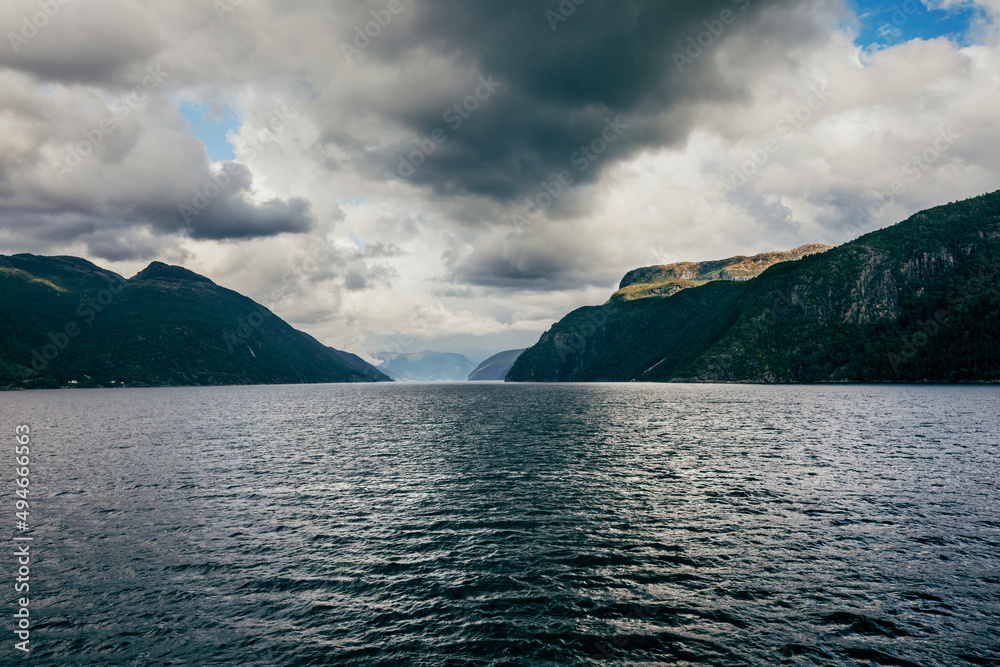 storm over the fjord in the sea of norway with mountains view