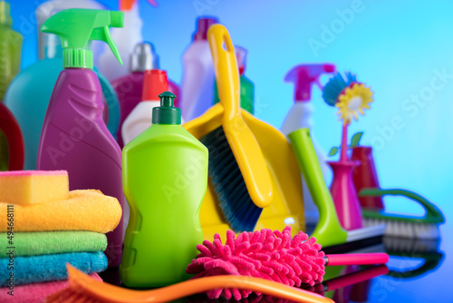 Sping cleaning. Cleaning products. Colorful cleaning kit on blue background.