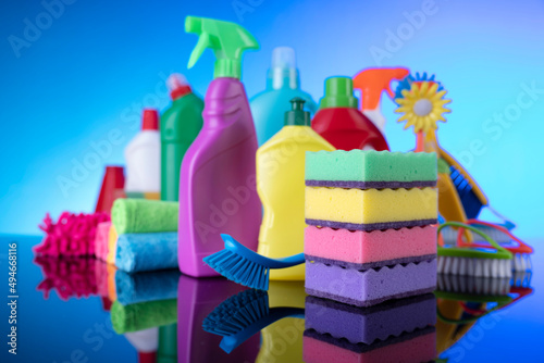 Sping cleaning. Cleaning products. Colorful cleaning kit on blue background.