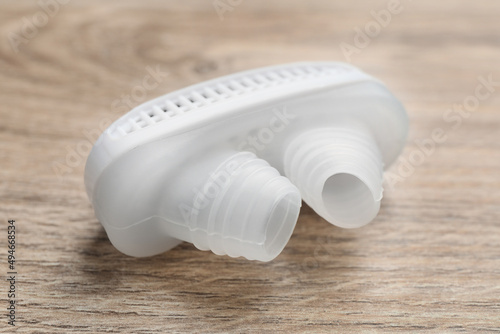 Anti-snoring device for nose on wooden table, closeup