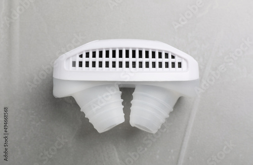 Anti-snoring device for nose on grey table, top view photo