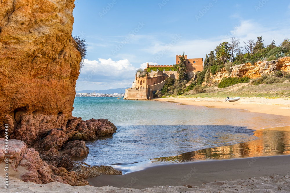 Coastline with sandy beach and the castle in Ferragudo, Algarve, Portugal