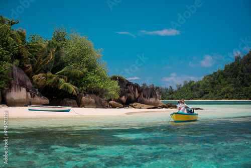 Two lovers and a boat on the paradise Seychelles