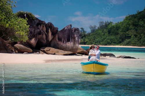 Two lovers and a boat on the paradise Seychelles