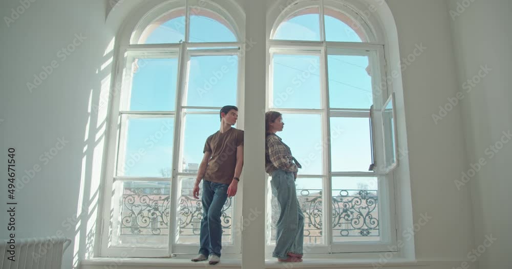 at two large windows, in one apartment, a man and a woman are separated. quarrel or misunderstanding, the desire to apologize and establish a relationship, a breakup, a divorce. 