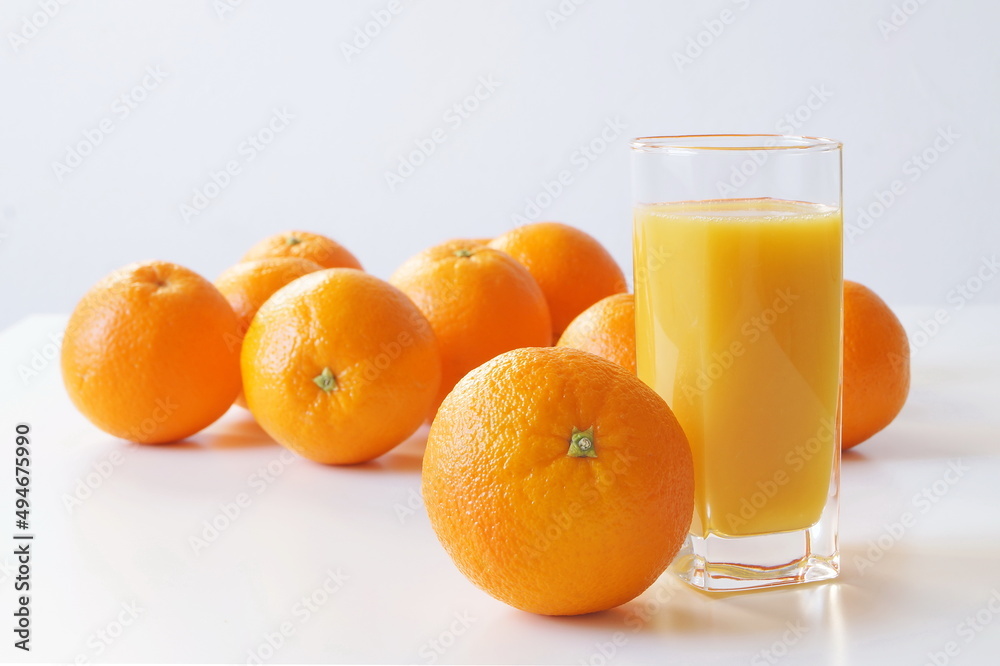 Oranges are on the table, also on the table is a glass of freshly squeezed juice for breakfast, a good start to the day and enriching the body with vitamin C Oranges are on the table, also on the table is a glass of freshly squeezed juice for breakfast, a good start to the day and enriching the body with vitamin C