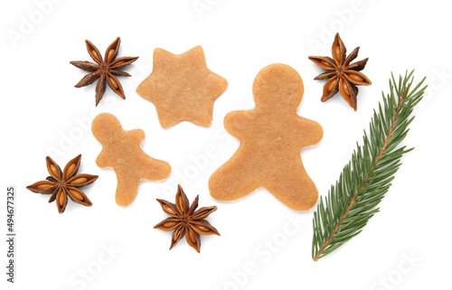 Unbaked Christmas cookies, anise and fir tree twig on white background, top view
