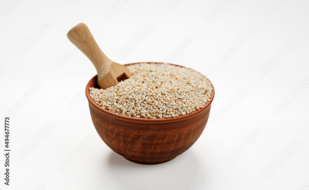 Barley groats in bowls and bags isolated on a white background. High quality photo Barley groats in bowls and bags isolated on a white background. High quality photo