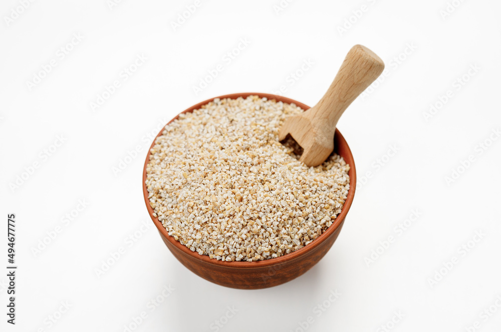 Barley groats in bowls and bags isolated on a white background. High quality photo Barley groats in bowls and bags isolated on a white background. High quality photo