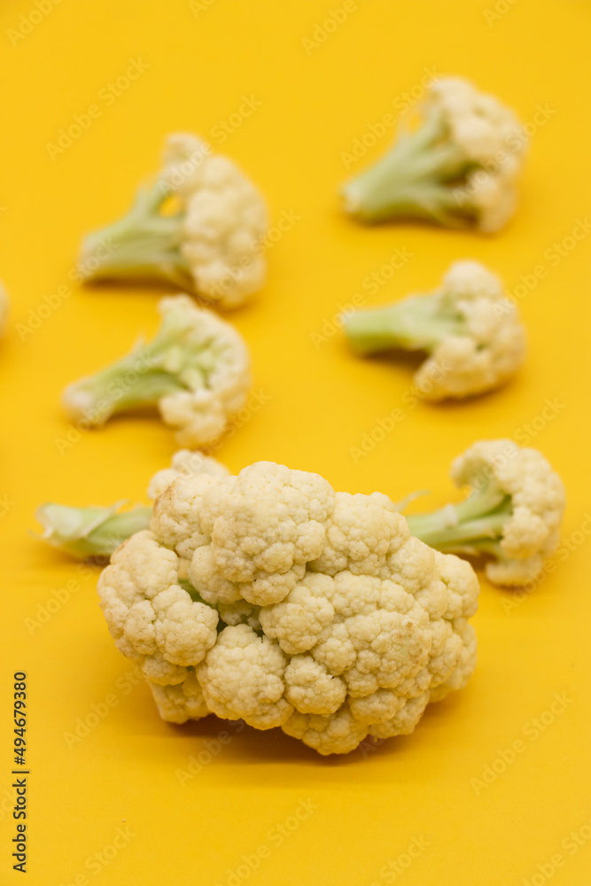 Ripe Cauliflower pieces isolated on yellow background, Ripe Cauliflower pieces isolated on yellow background,