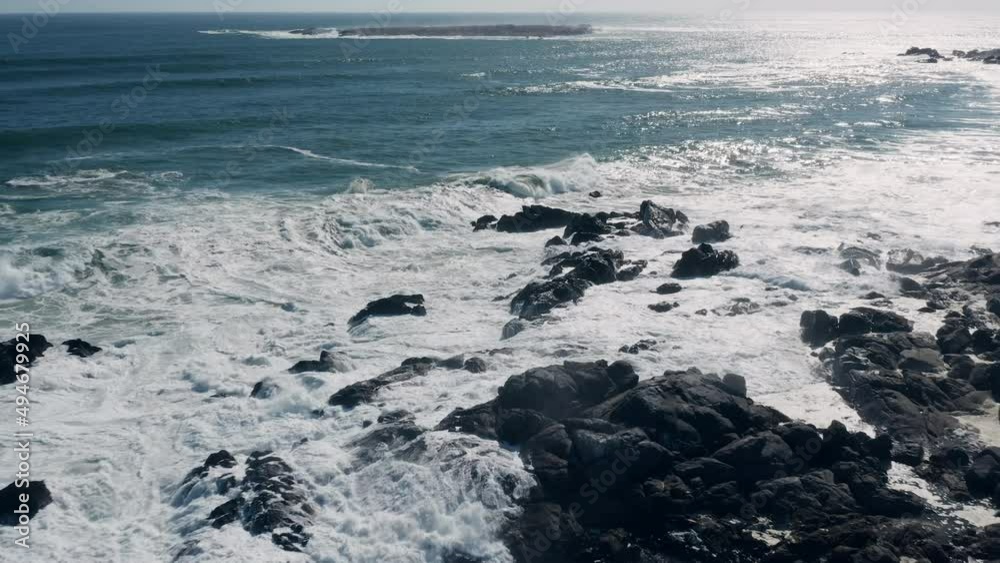 Aerial View Of Foamy Ocean Waves Crashing On The Rocks At The Beach In West Coast National Park, South Africa - drone shot Aerial View Of Foamy Ocean Waves Crashing On The Rocks At The Beach In West Coast National Park, South Africa - drone shot