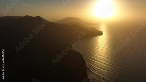 Glenbeigh, Kerry, Ireland, March 2022. Drone slowly pulls east high above the Iveragh Peninsula looking west towards Kells, Portmagee and the beautiful golden sunset. photo