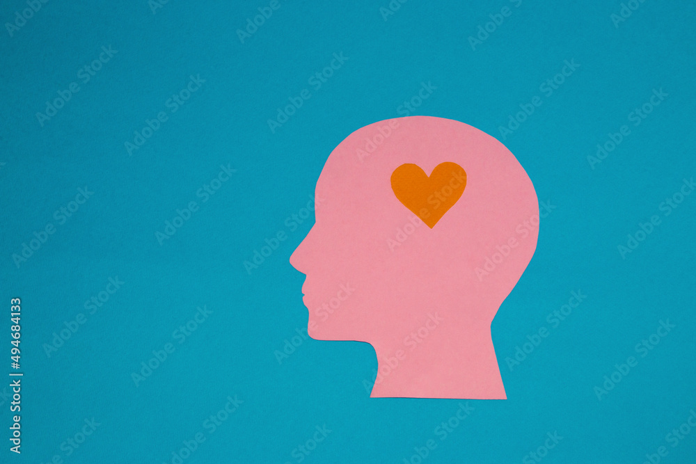 pink paper head instead of brain has a little orange heart, infatuation, flat design, human emotions,copy space