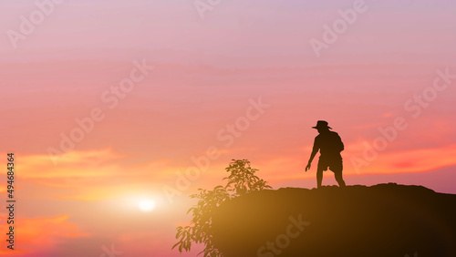 Silhouette people standing on mountain sunset background