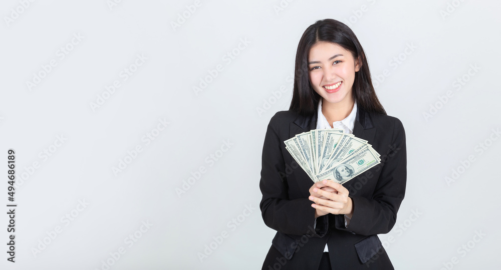 confident portrait beautiful asian woman successful wearing office clothing with US dollars money in hand feeling happy and smile, bankruptcy economic financial concept. confident portrait beautiful asian woman successful wearing office clothing with US dollars money in hand feeling happy and smile, bankruptcy economic financial concept.