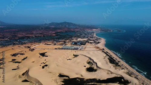 Wallpaper Mural Coastal yellow sandy dunes with city in horizon in Vietnam, high altitude drone view Torontodigital.ca