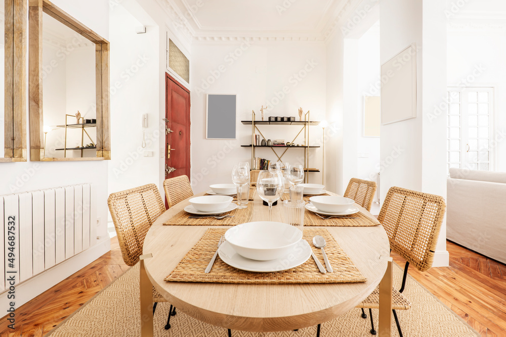 Fototapeta premium Dining table in natural color with matching fiberglass mesh chairs and pine wood flooring