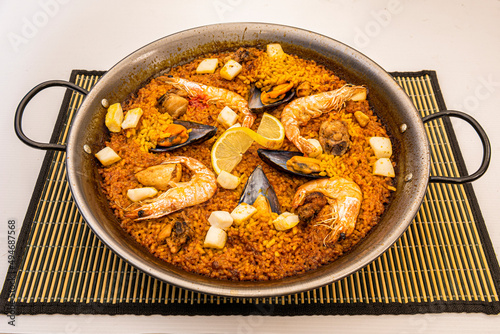 Valencian seafood paella with golden rice in a paella pan