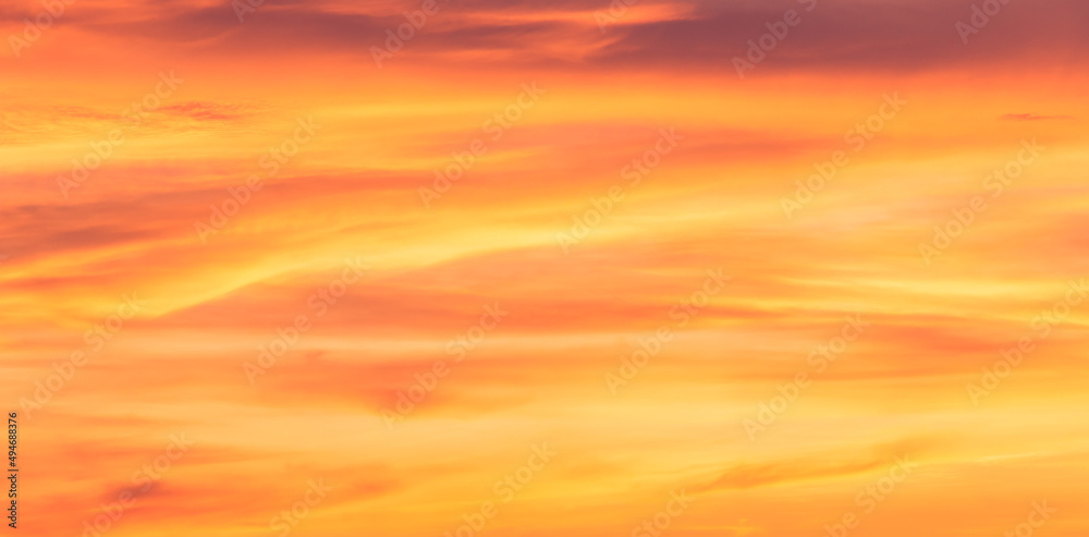 Orange sunrise sky clouds background in the evening, Romantic sky pastel with dramatic yellow clouds fluffy