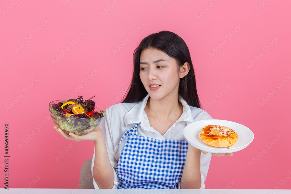 happy young asian woman choose to eat fresh orange apple fruits with copy space pink background, health care eat vegetables and useful foods lifestyles concept. happy young asian woman choose to eat fresh orange apple fruits with copy space pink background, health care eat vegetables and useful foods lifestyles concept.