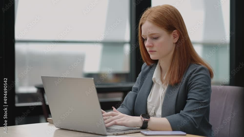 woman is working with laptop in office, typing e-mail for partners and employees, serious and successful businesswoman woman is working with laptop in office, typing e-mail for partners and employees, serious and successful businesswoman