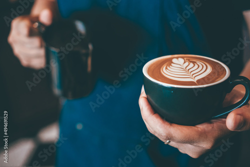 Cup of coffee latte art with coffee shop.