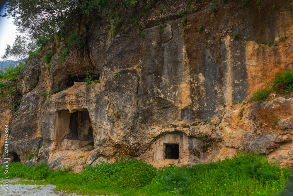 AKYAKA, MUGLA, TURKEY: Ancient Lycian tombs carved into the rock in the village of Akyaka.