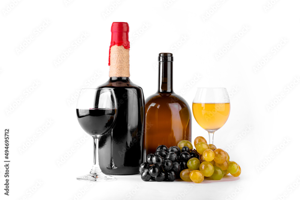 Red and white wine bottle with wine glasses and grapes on white background.