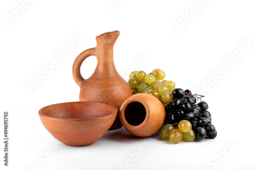 Georgian traditional clay vessel kvevri (qvevri ),piala, and jug(doqi)  for wine and grapes on white isolated background. photo