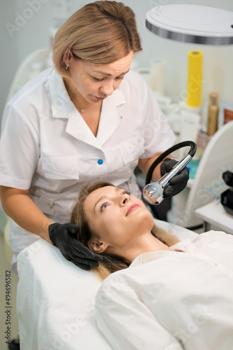 Electroporation procedure close-up. Girl on a cosmetic procedure photo