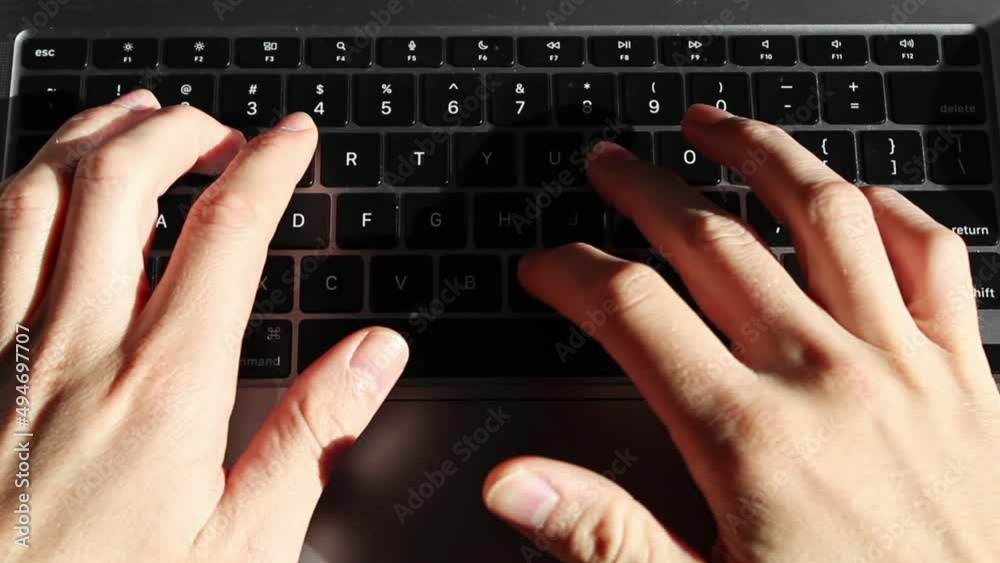Static overhead shot of Caucasian person typing on a laptop keyboard on desk. Static overhead shot of Caucasian person typing on a laptop keyboard on desk.