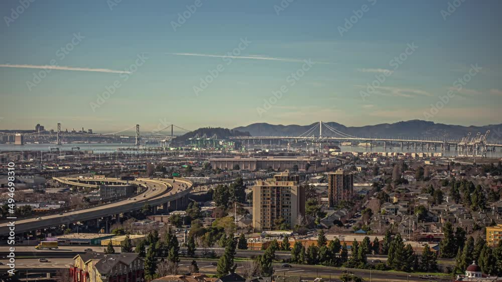 Time lapse panorama shot of traffic on highway during sunny day in San Francisco cityscape - Golden Gate Bridge and silhouette of mountains in background Time lapse panorama shot of traffic on highway during sunny day in San Francisco cityscape - Golden Gate Bridge and silhouette of mountains in background