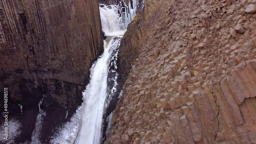 Litlanesfoss is a very beautiful small waterfall on the Iceland - It is carved into basalt rocks photo