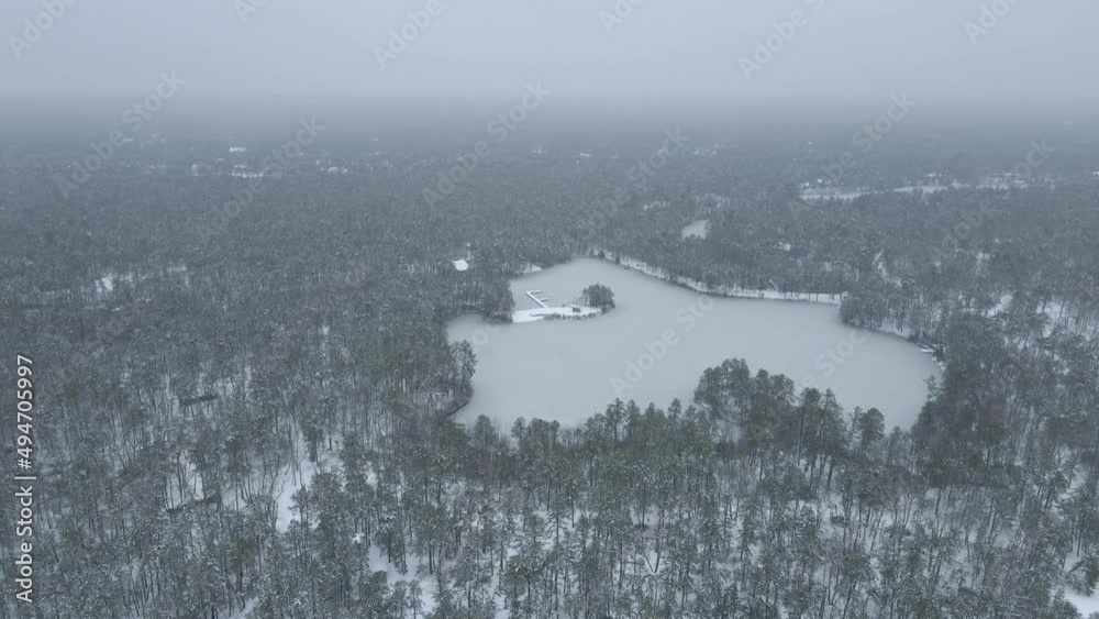 Thick Fog Over Frozen Lake And Snowy Forest In New Jersey At Winter. wide aerial Thick Fog Over Frozen Lake And Snowy Forest In New Jersey At Winter. wide aerial