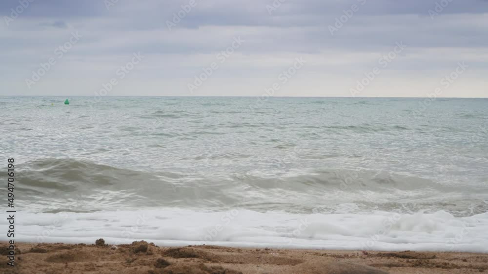 Low angle view of a sandy beach as waves wash ashore. Low angle view of a sandy beach as waves wash ashore.