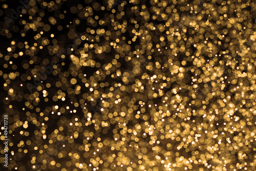 Golden background. Abstract gold background. Festive Golden Christmas Background.Background is glittering with golden light,bokeh defocused light.