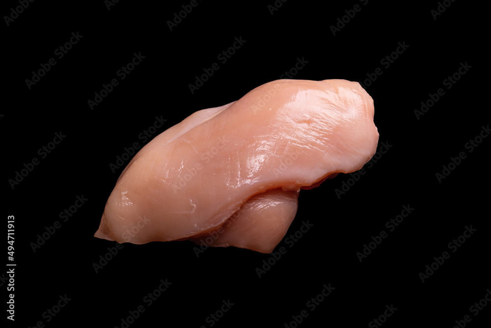 Fototapeta premium Raw chicken fillet isolated on a black background.