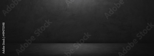 Dark grey cement wall room empty studio backdrop and rough floor with soft light well editing displays products and text present on free space concrete background
