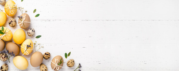 Easter eggs with flowers on a white table.
